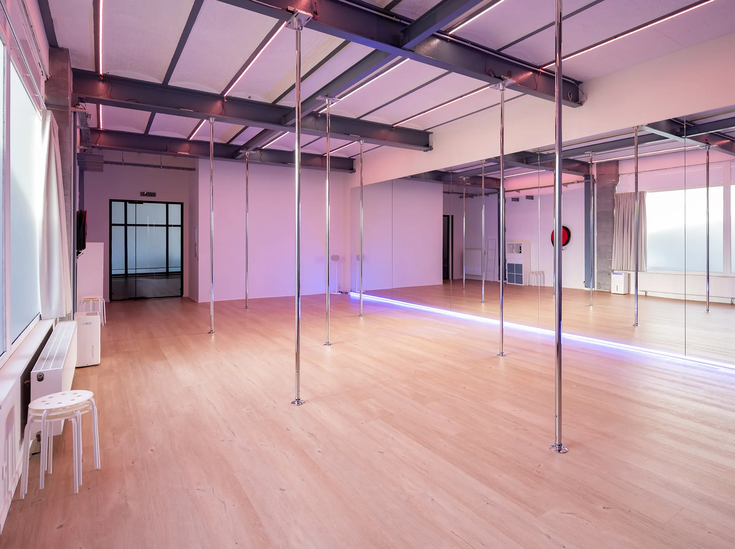 Wide-angle view of Flow Factory studio with poles